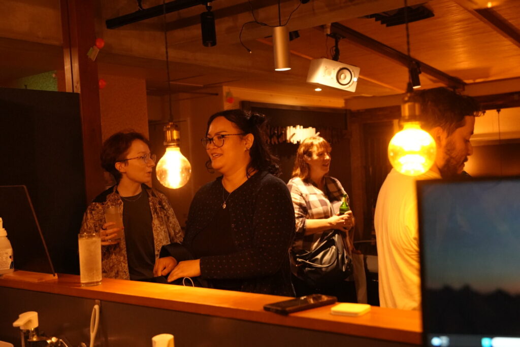 Guests chatting over drinks at the bar
