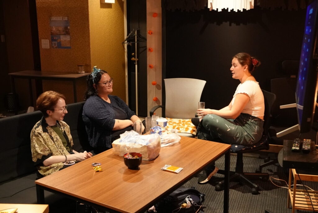 A group relaxing around a table with snacks